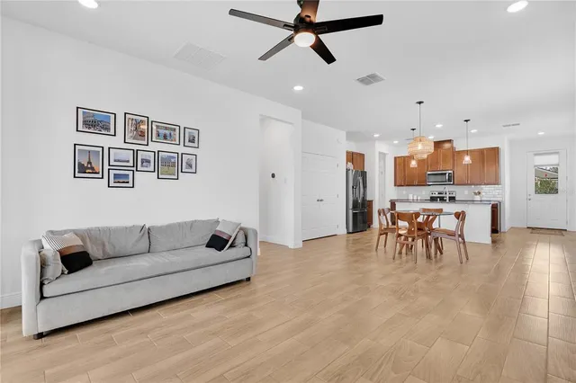 a living room with furniture and kitchen view