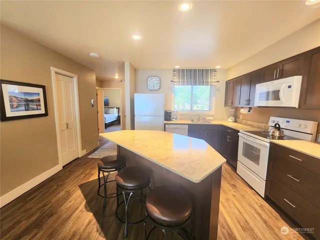 a large kitchen with cabinets table and chairs