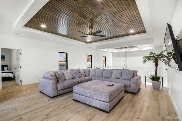 a living room with furniture a ceiling fan and a rug