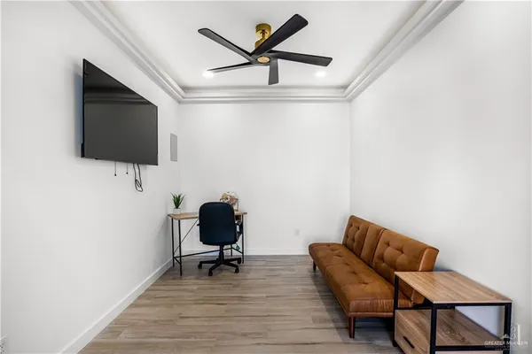 a work room with furniture and a flat screen tv
