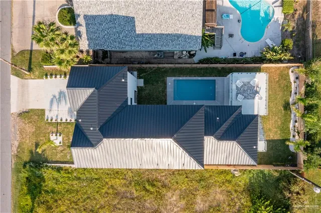 an aerial view of a house with a yard