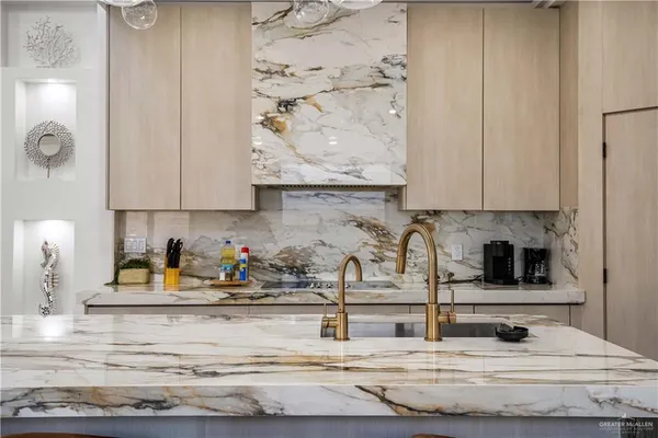 a kitchen with granite countertop white cabinets and sink