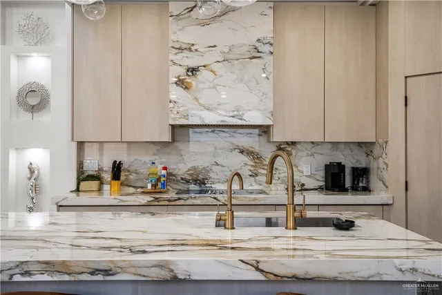 a kitchen with granite countertop white cabinets and sink