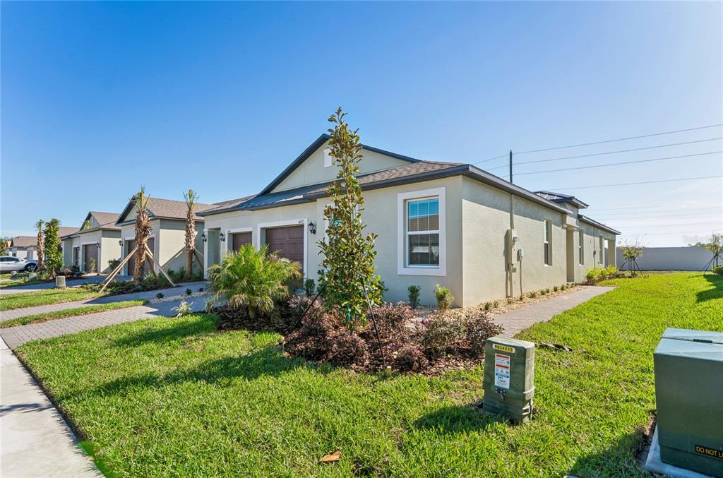 6692 Homebound Way New Port Richey, FL 34653 - Photo 43 of 47 a front view of house with yard and green space