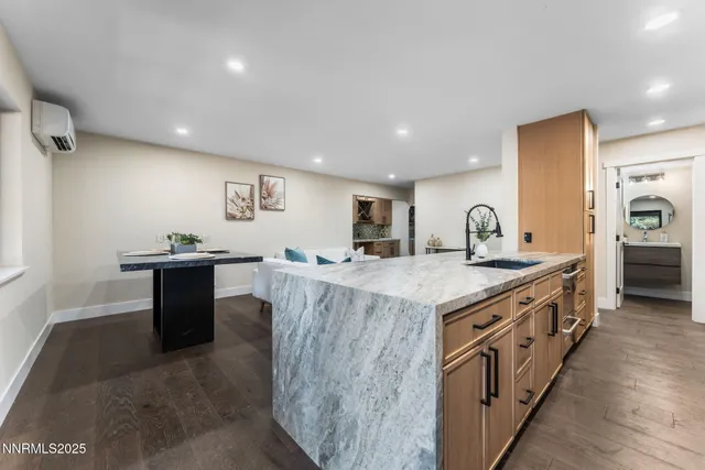 a large kitchen with stainless steel appliances granite countertop a lot of counter space and wooden floor