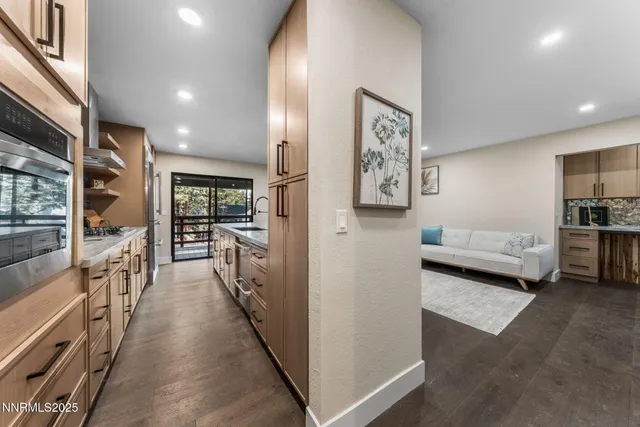a view of a hallway with furniture and a living room