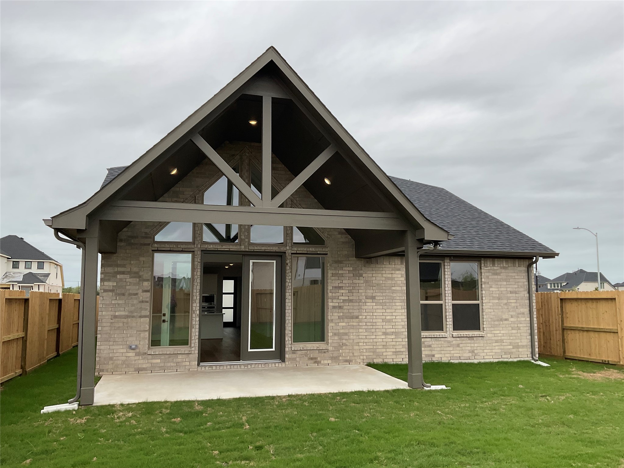 6011 Rolling Strm Court Fulshear, TX 77441 - Photo 14 of 28 Relaxation awaits on our high-ceiling covered patio, offering a tranquil retreat with a view of the bOur high-ceiling covered patio offers a tranquil retreat with a view of the backyard, perfect for relaxation. backyard.