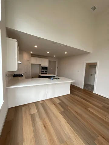 a view of kitchen with kitchen island microwave and stove
