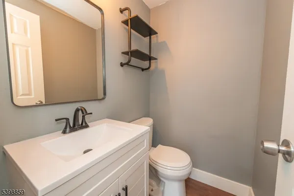 a bathroom with a sink a toilet and mirror