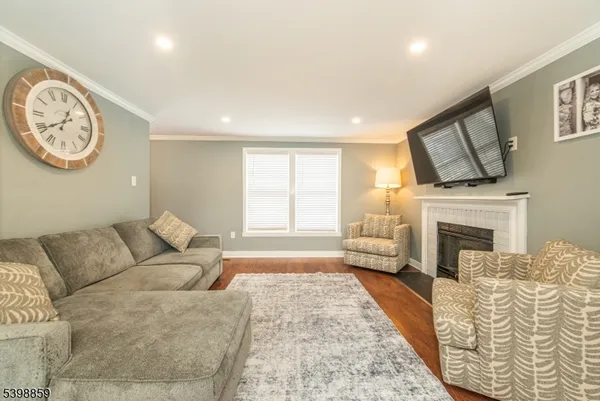 a living room with furniture a large window and a fireplace