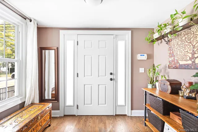 a view of a livingroom with wooden floor and a potted plant