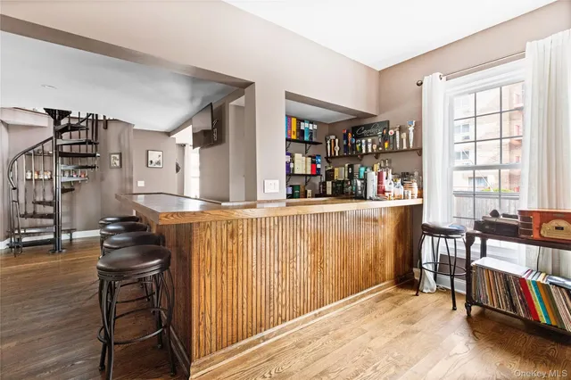 a room with lots of wooden furniture and windows