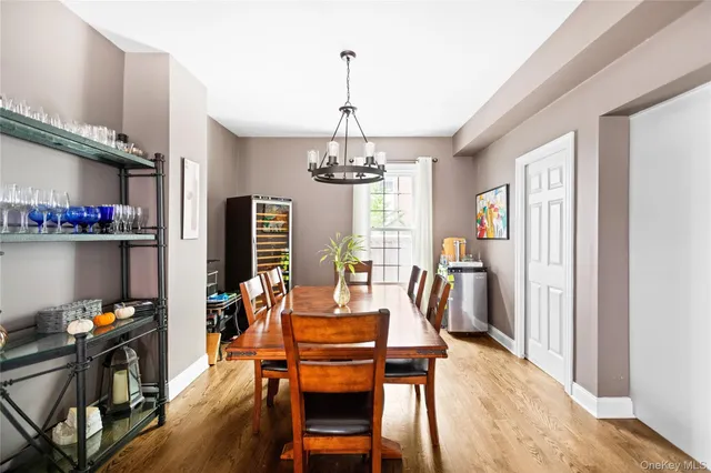 a dining room with furniture window and wooden floor