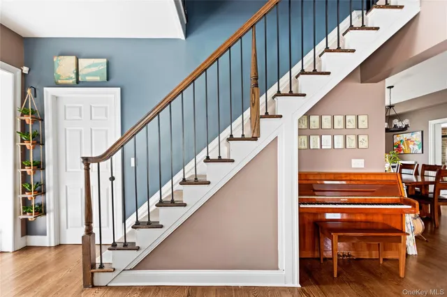 a view of entryway and hall with wooden floor