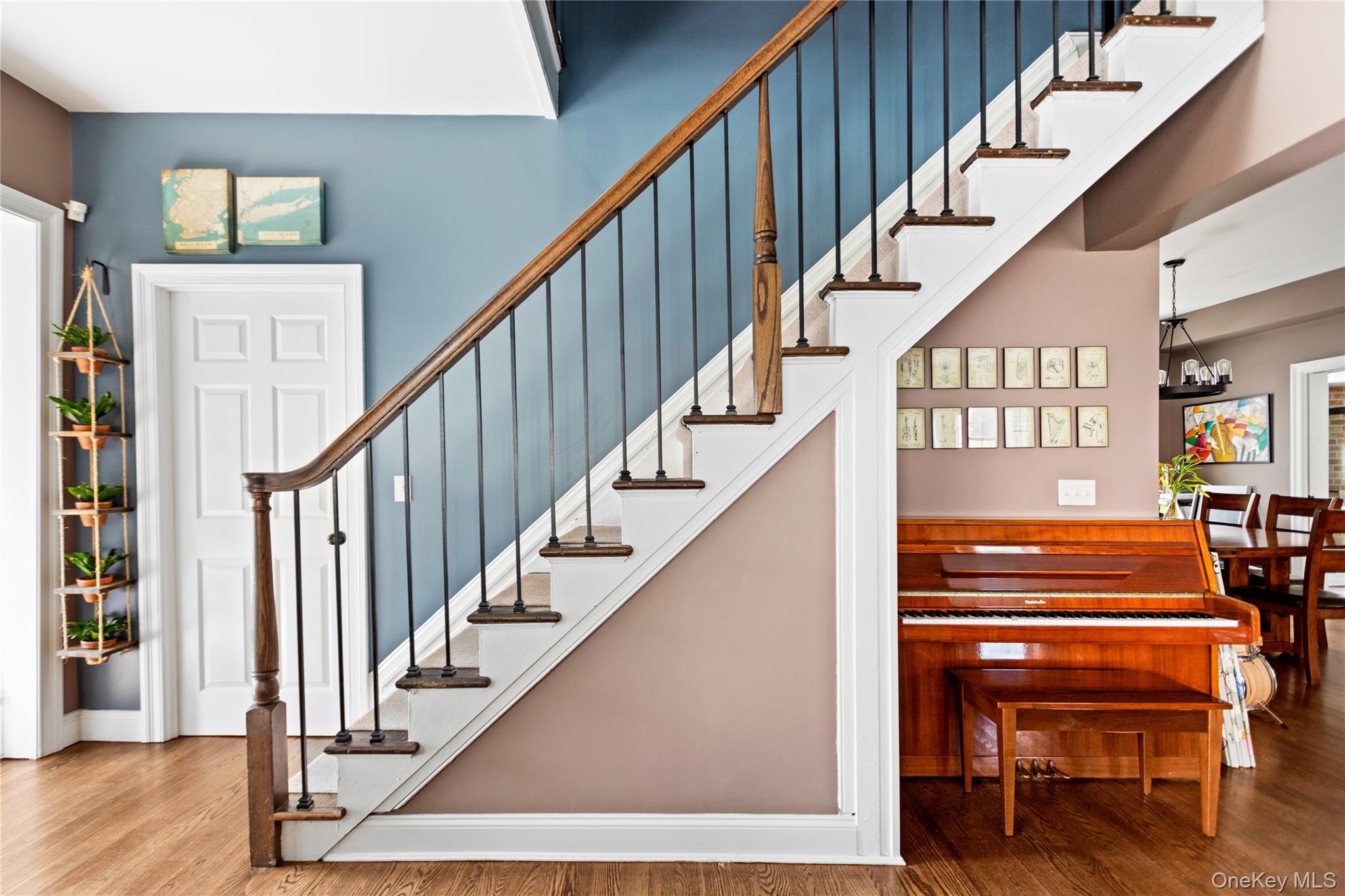 10 Maple Avenue Patchogue, NY 11772 - Photo 15 of 28 Foyer entrance with wood finished floors, stairs, and a chandelier