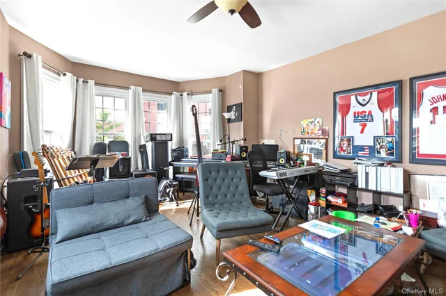 a living room with furniture and a floor to ceiling window