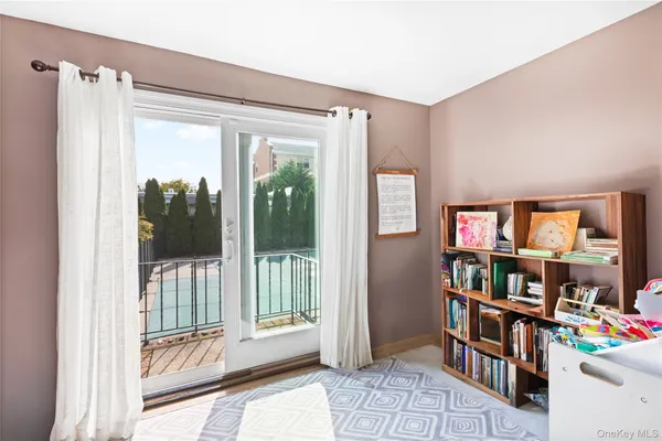 a living room with lots of furniture and a book shelf