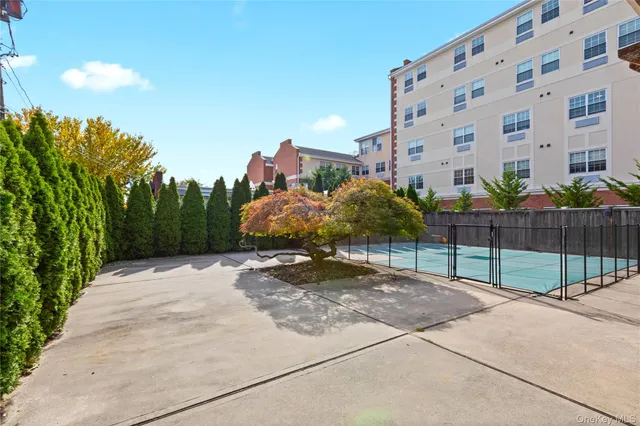 a view of a tall building next to a yard