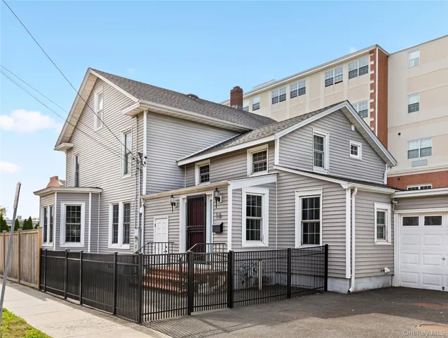 a view of a white house with large windows