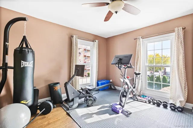 a room with gym equipment and windows