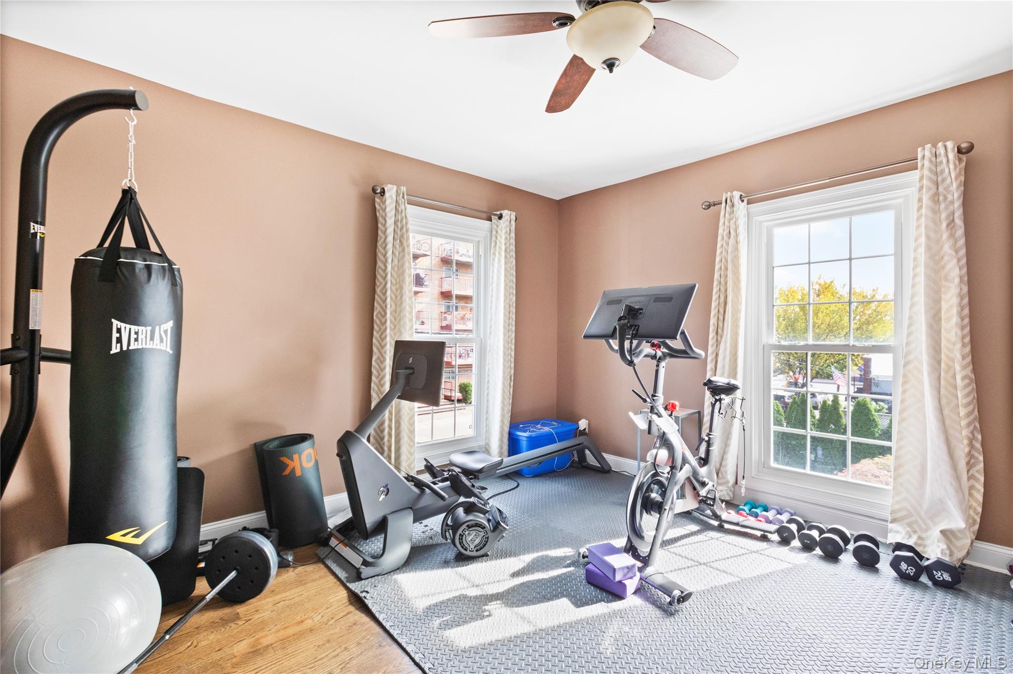 10 Maple Avenue Patchogue, NY 11772 - Photo 24 of 28 Exercise room with plenty of natural light, wood finished floors, and a ceiling fan