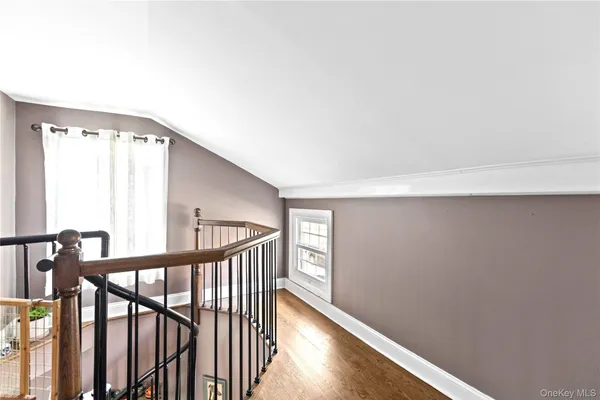a view of staircase with railing and a window