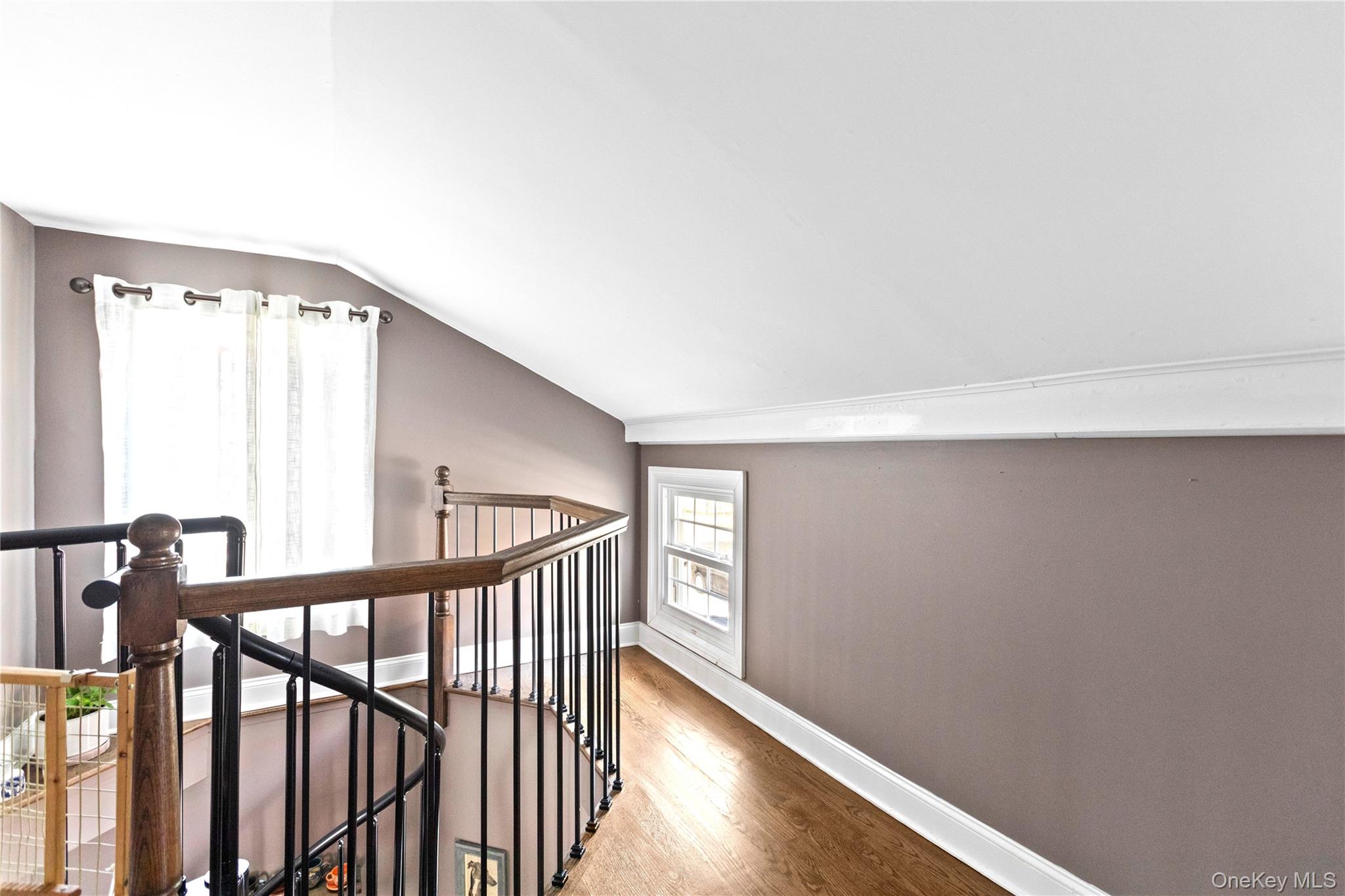 10 Maple Avenue Patchogue, NY 11772 - Photo 26 of 28 Corridor with lofted ceiling, an upstairs landing, and wood finished floors