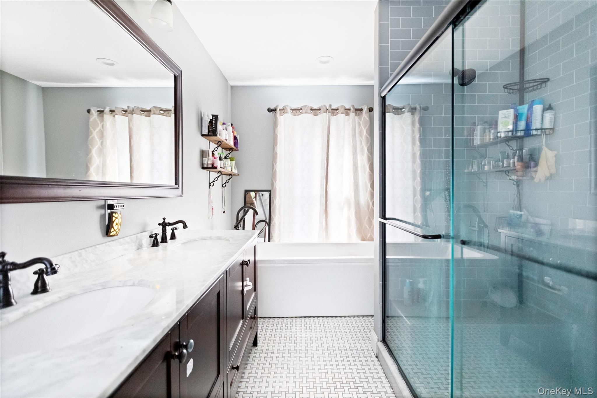 10 Maple Avenue Patchogue, NY 11772 - Photo 28 of 28 Bathroom with double vanity, a shower stall, and a tub