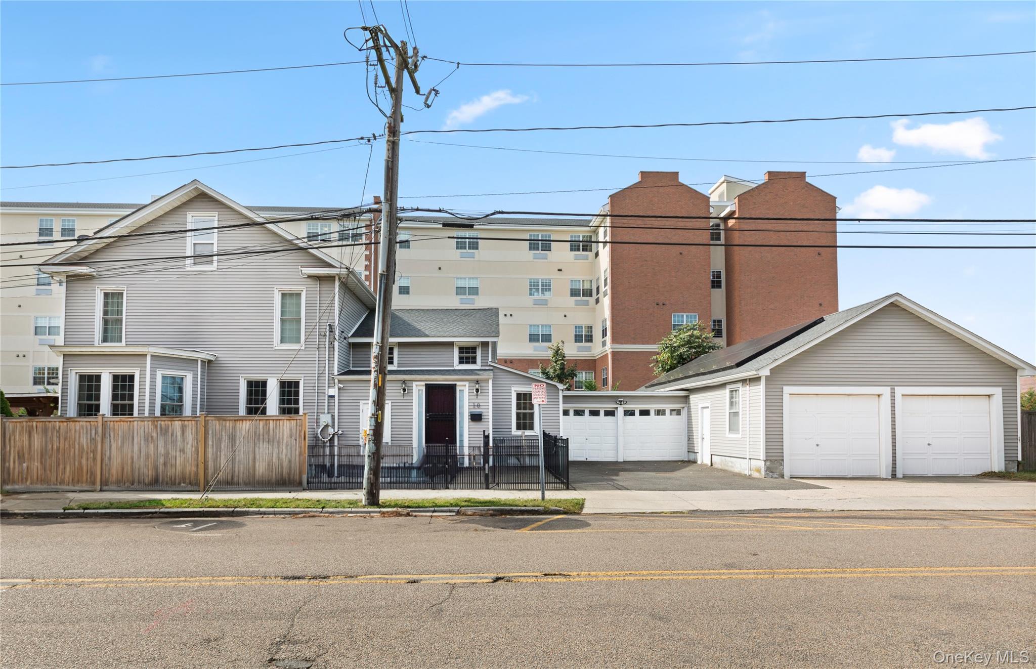 10 Maple Avenue Patchogue, NY 11772 - Photo 6 of 28 View of front facade featuring a fenced front yard and an outdoor structure