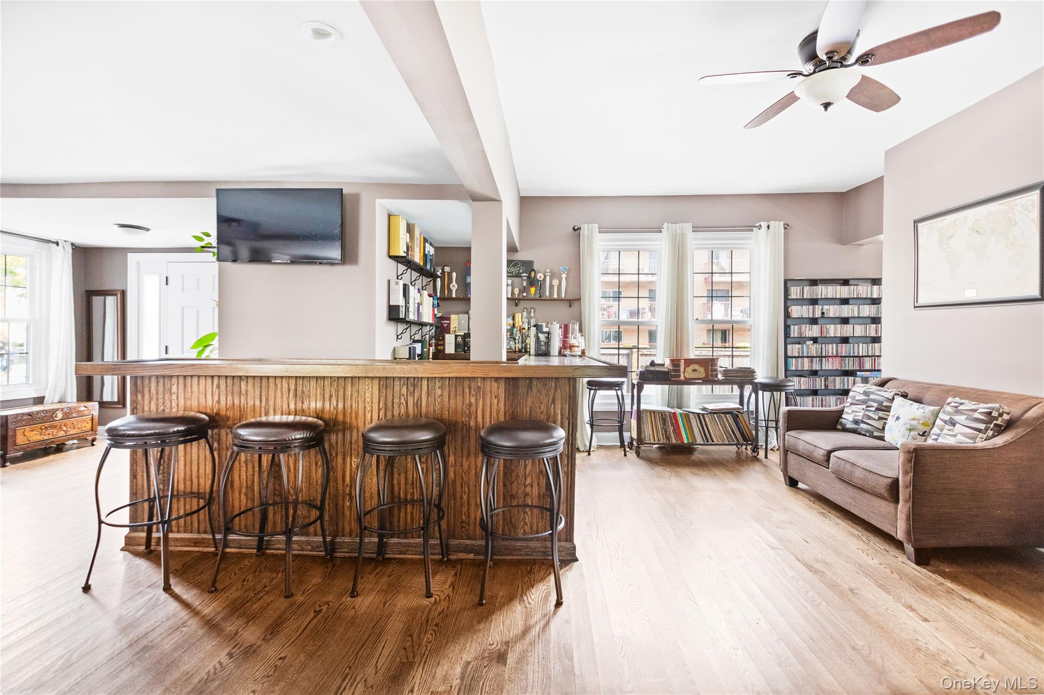 10 Maple Avenue Patchogue, NY 11772 - Photo 10 of 28 Indoor dry bar featuring light wood-type flooring, a ceiling fan, and beamed ceiling
