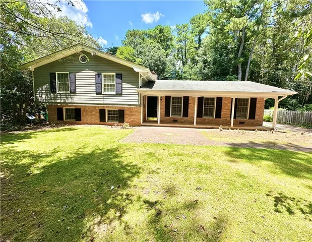 a front view of a house with a yard table and chairs