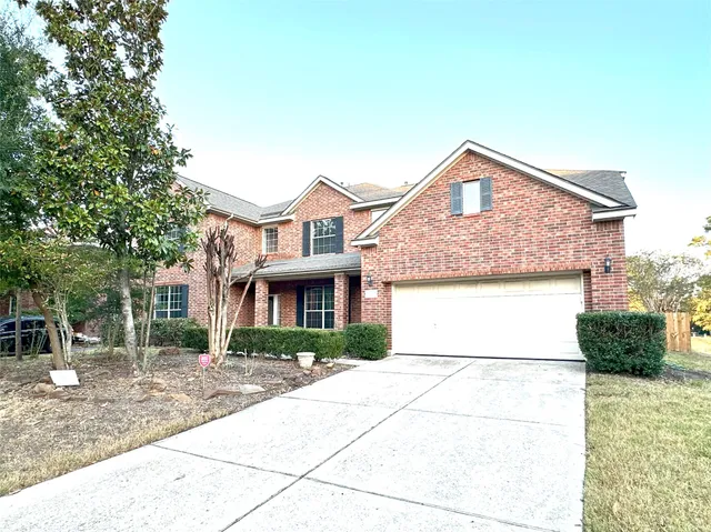 front view of a brick house with a yard
