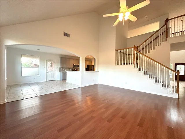 a kitchen with stainless steel appliances kitchen island sink refrigerator stove and cabinets