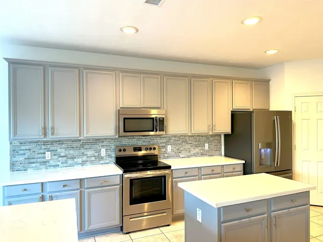 a view of a hallway with wooden floor and a window