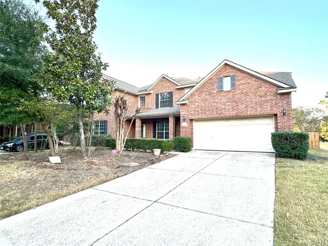 a view of a hallway with wooden floor and a living room