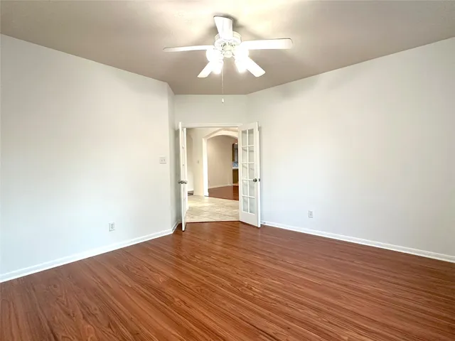 a view of a living room with hardwood floor and a window