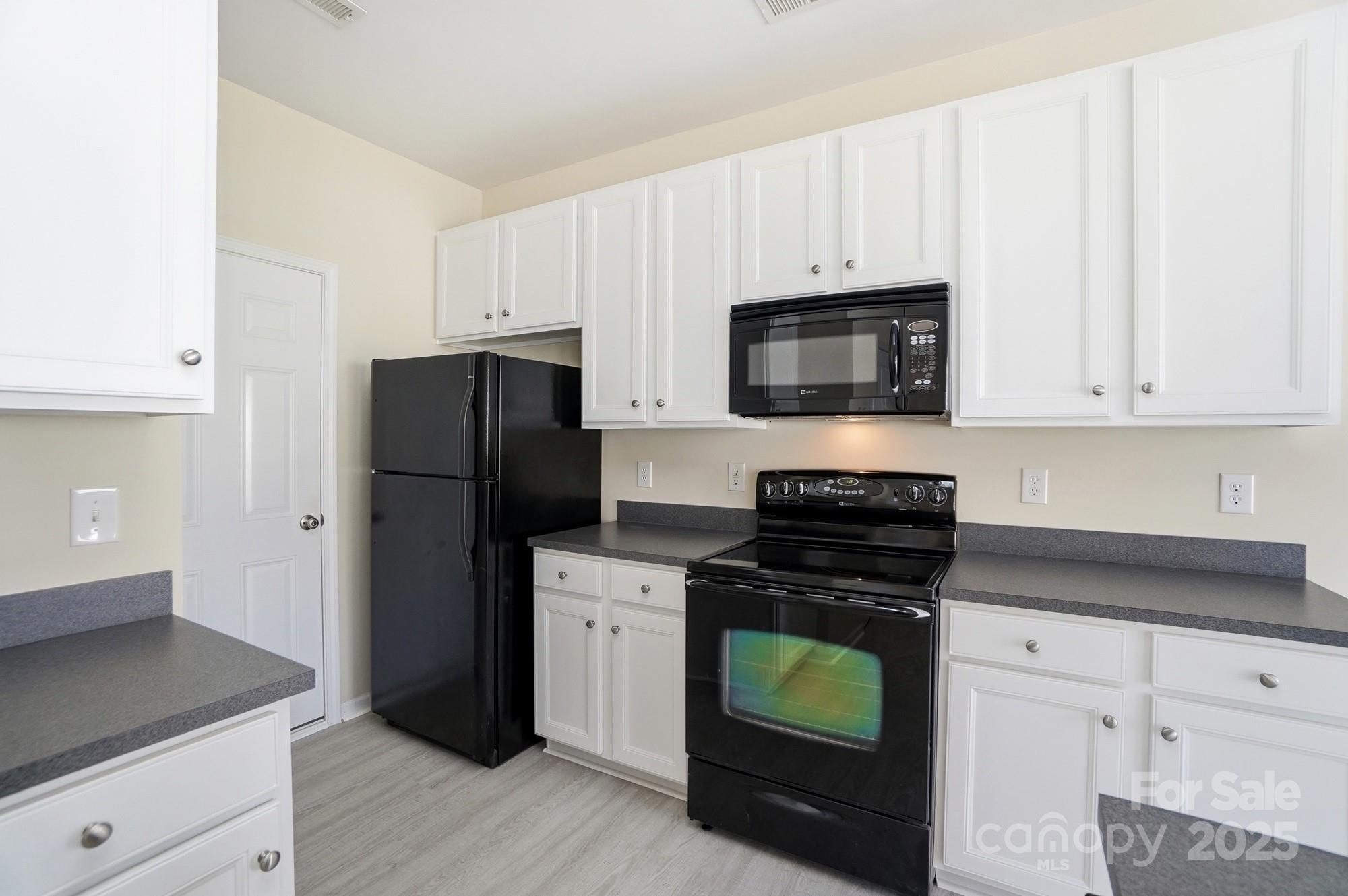 224 Sand Paver Way Fort Mill, SC 29708 - Photo 15 of 42 a kitchen with cabinets and steel stainless steel appliances