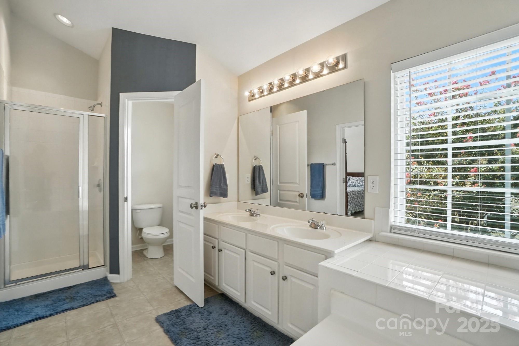 224 Sand Paver Way Fort Mill, SC 29708 - Photo 25 of 42 a spacious bathroom with a double vanity sink a mirror and a shower