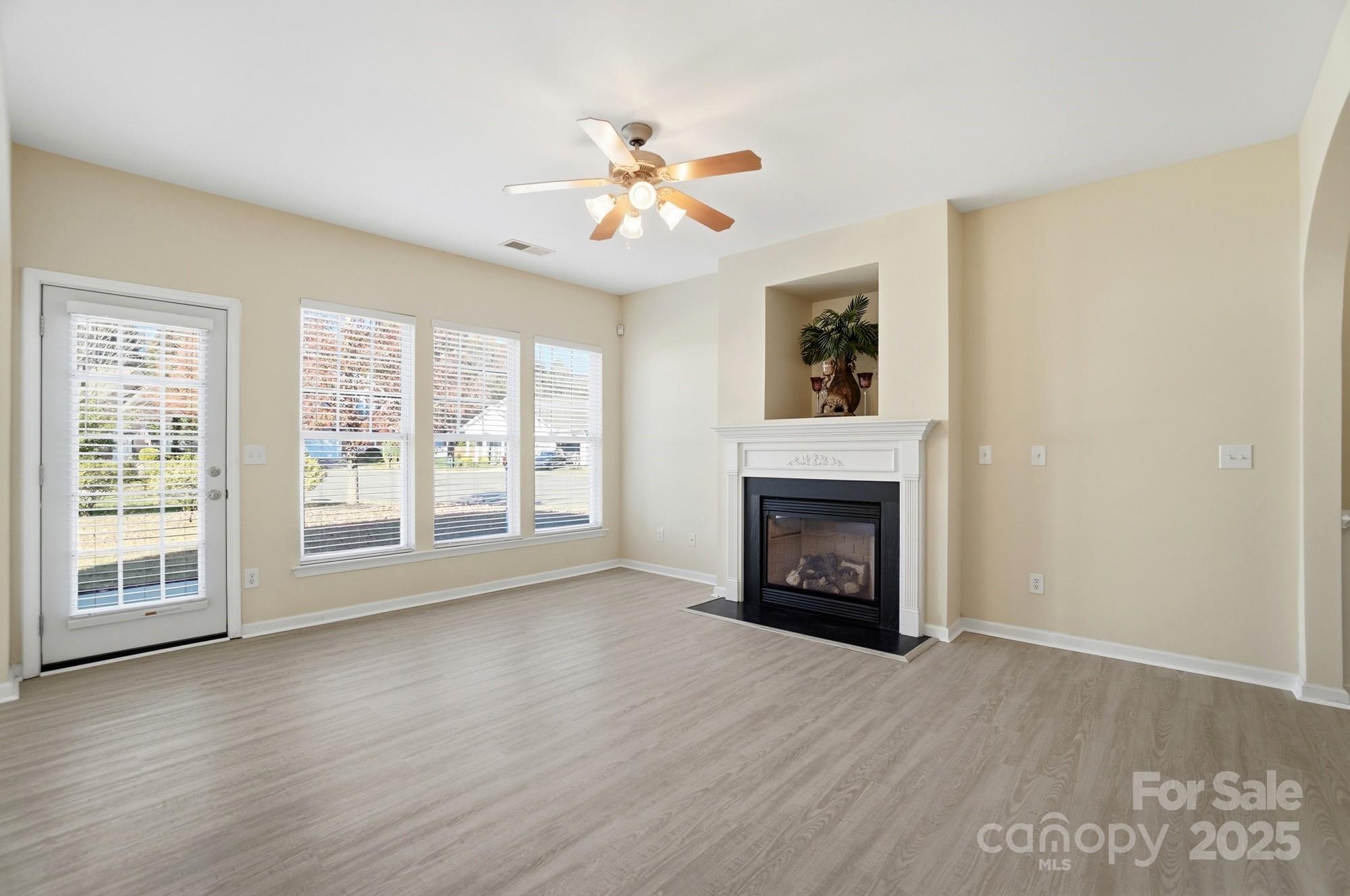 224 Sand Paver Way Fort Mill, SC 29708 - Photo 4 of 42 a view of an empty room with wooden floor fireplace and a window