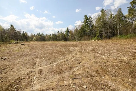 a view of open space with wooden fence
