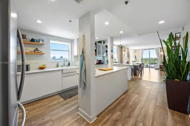 a kitchen with stainless steel appliances granite countertop a sink and a refrigerator