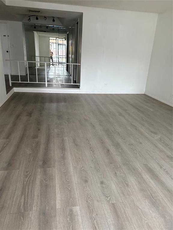 3710 Inverrary Drive, Unit 1Y Lauderhill, FL 33319 - Photo 11 of 17 a view of an empty room with wooden floor and a window