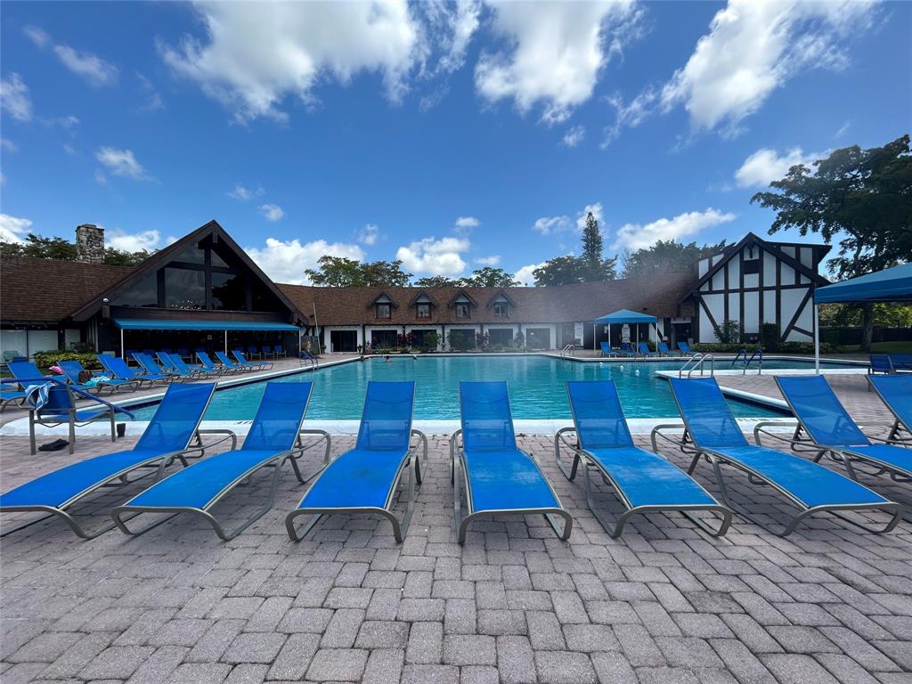 3710 Inverrary Drive, Unit 1Y Lauderhill, FL 33319 - Photo 13 of 17 a view of playground with lawn chairs and iron fence