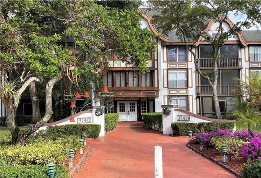 3710 Inverrary Drive, Unit 1Y Lauderhill, FL 33319 - Photo 17 of 17 a view of a house with a yard and potted plants