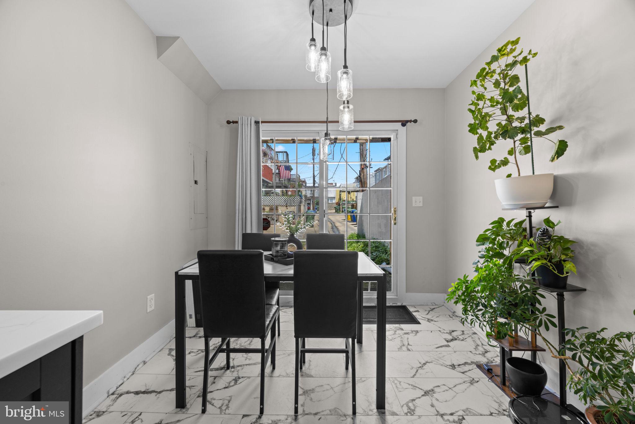 3208 Elliott Street Baltimore, MD 21224 - Photo 17 of 42 a view of a dining room with furniture and chandelier