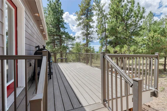 a view of balcony with two chairs and wooden floor