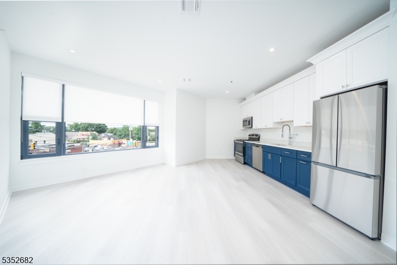 12 River Road, Unit 303 Fair Lawn, NJ 07410 - Photo 11 of 16 a large kitchen with a large window and stainless steel appliances