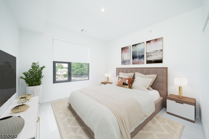12 River Road, Unit 303 Fair Lawn, NJ 07410 - Photo 5 of 16 a bedroom with a large bed and a window