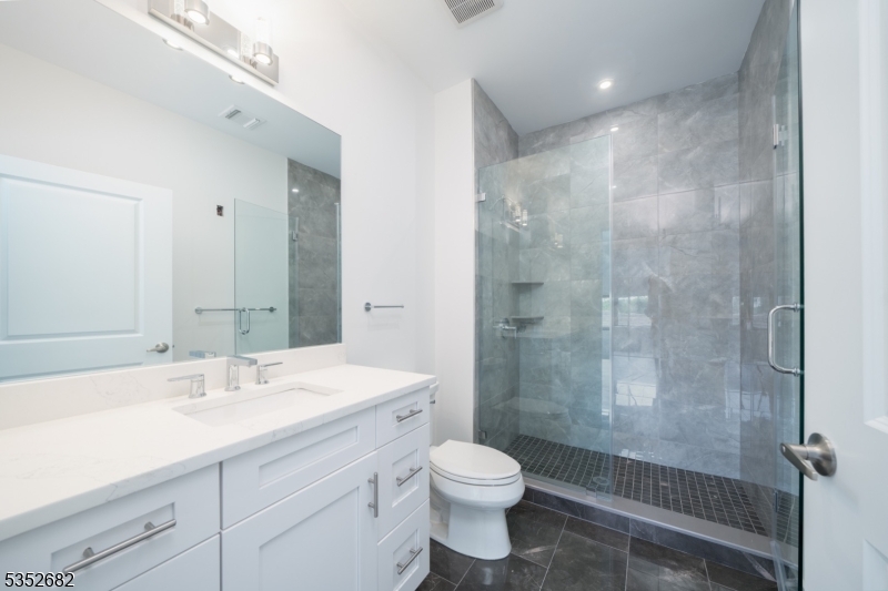 12 River Road, Unit 303 Fair Lawn, NJ 07410 - Photo 6 of 16 a bathroom with a sink a toilet and shower