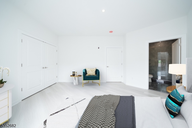 12 River Road, Unit 303 Fair Lawn, NJ 07410 - Photo 7 of 16 a bed room with a bed and a couch